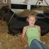 Kaydence Lay relaxes during the Lewis County Fair in the cow barn. Good crowds attended the fair which is an annual tradition for many Lewis County residents. (Photo by Rita Cox)