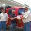 Eric Happekotte (right) and Dan Patterson (left) of the Missouri Department of Conservation, Forestry Division, present a check to Joe LaCounty (center) for the Canton Fire Department.