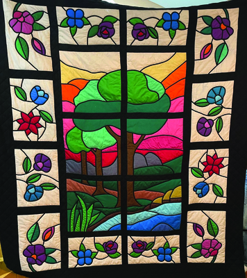 Stain Glass quilt, a blue ribbon winner and best of show at the 1985 Lewis County Fair, created by Inez Gregory.
