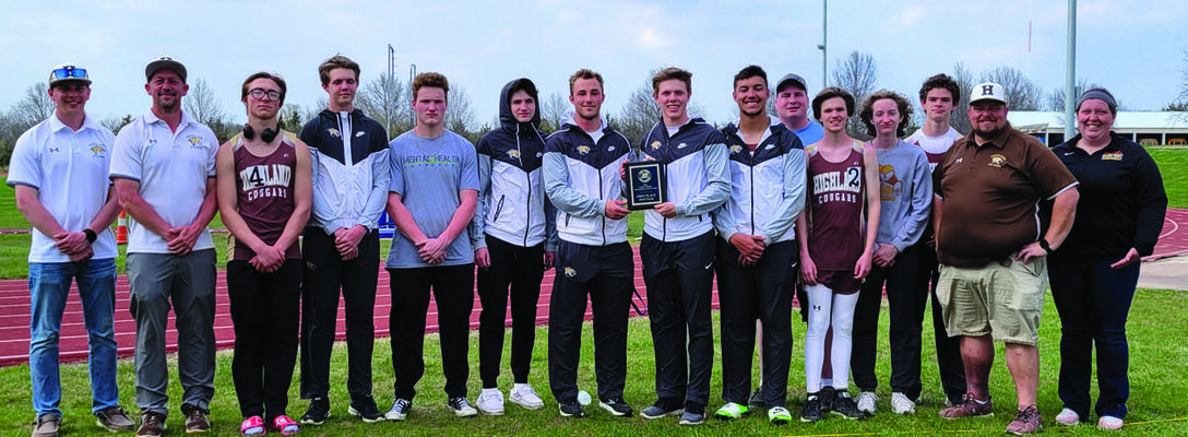 Members and coaches of the boys track team pictured with the first place plaque after winning the Gary Ewing Invite.