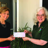 Lewis Street Playhouse president Dell Ann Janney receives a grant check from Canton Area Arts Council Board president Carol Mathieson.