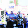 Culver-Stockton College President Mary Thompson waves to the crowd of parade views as she is driven down the Canton streets in an antique automobile owned and driven by Bill Dorris.