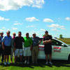 Tracy Job of Shottenkirk and other players with a new Toyota Camry at hole nine. Players had a chance to win the car by making a hole in one on the ninth green at the Kiwanis Golf Tournament held September