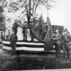Otto Bruner Post 170 stand with their decorated float on Oct. 17, 1930. The uniformed personnel are pictured a little more than a decade after World War I, and a decade before World War II. The men are identified as Elmer Fleming, Fred Howell, Jim Cecil, Harry Ward, Lee Schlager, Jack Treft, Cecil Jobe and Harold Stow. The Otto Bruner Post is still very active in the community