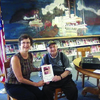 Al Beck presents Canton Public Library's Carol Hill with a copy of "WHO OWNS AL'S POETIC BONES?"