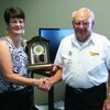 Sheree Webb, Northeast Missouri Regional Director, presents Norman Adams with a 25 year anniversary clock.