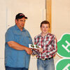 Lewis County 4-H Council President Rick Hinton presents David Lemmon with the two gold medals he earned in the .22 divisions he competed in at the State 4-H Shoot.